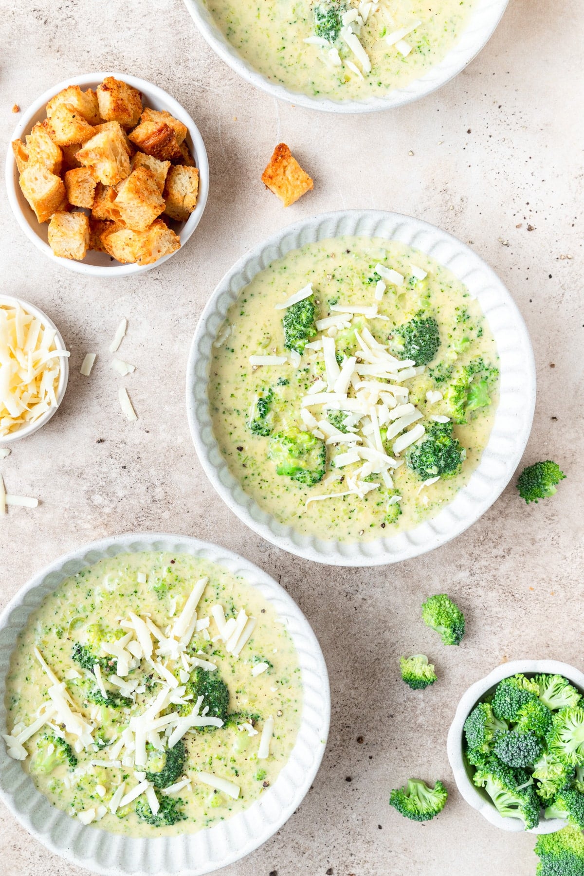 two bowls of creamy broccoli cheddar soup.