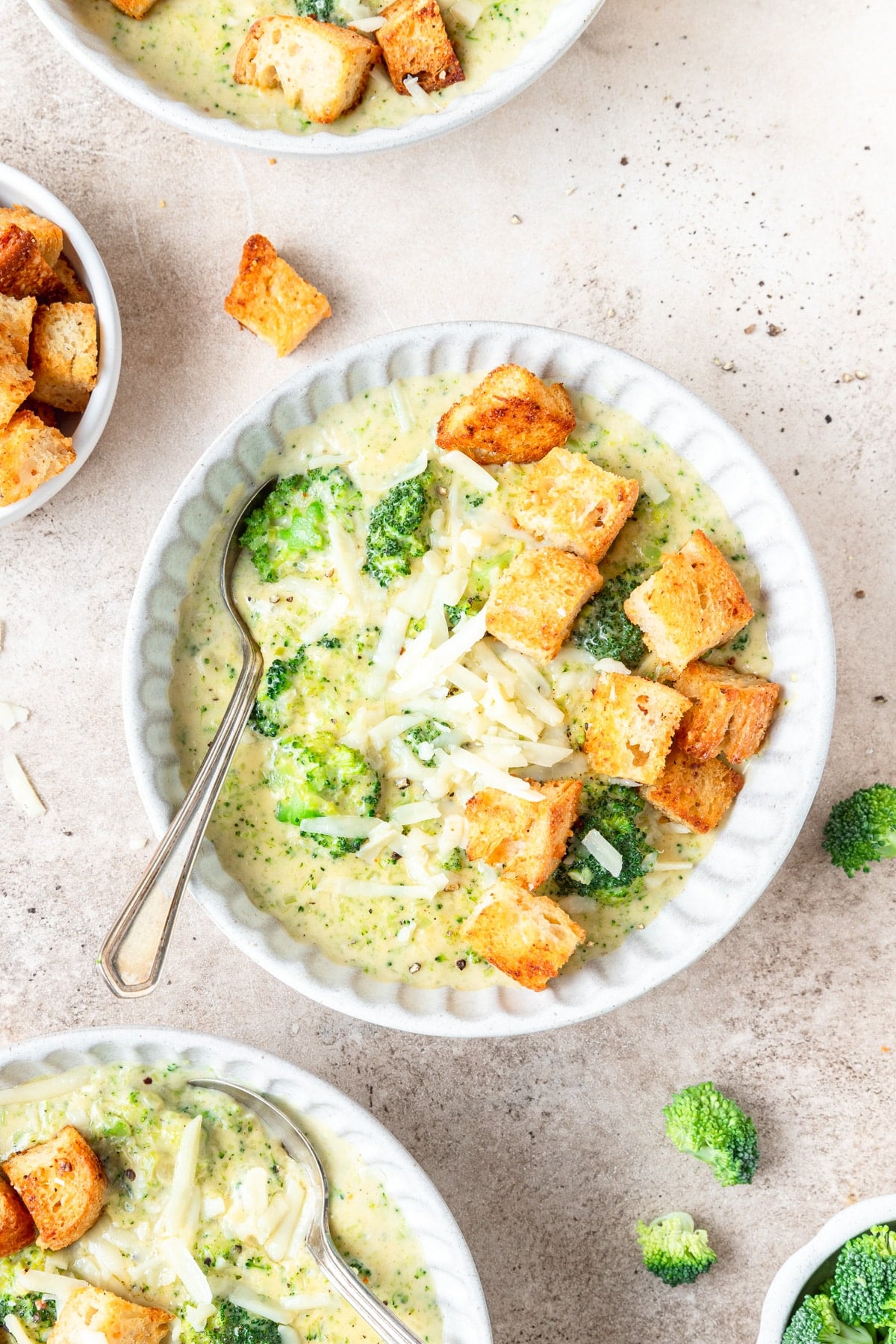 bowls of broccoli white cheddar soup with homemade croutons. 