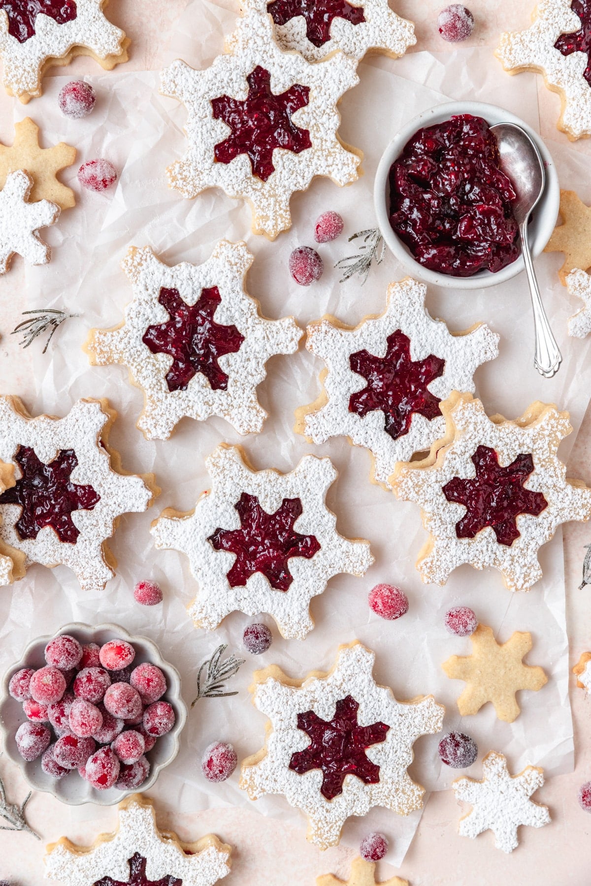 snowflake linzer cookies filled with cranberry sauce.