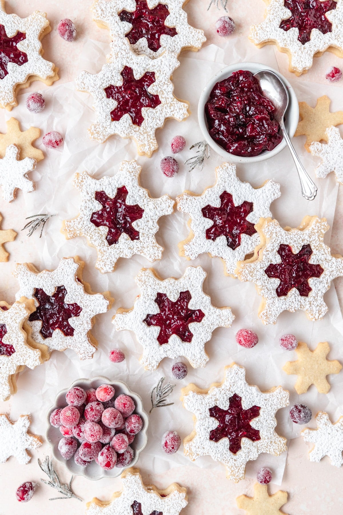 cranberry linzer cookies shaped like snowflakes.