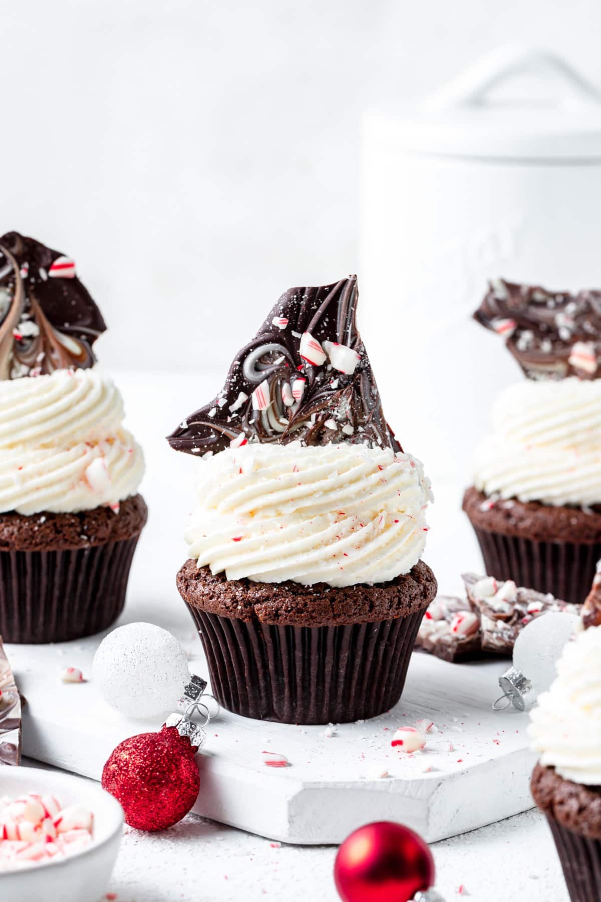 chocolate cupcakes topped with marbled peppermint bark.