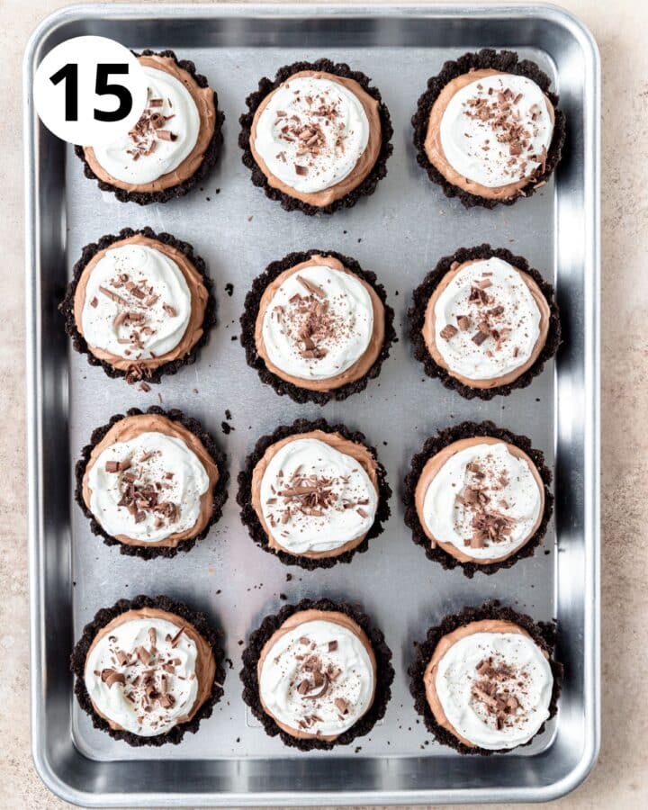 sprinkling chocolate shavings over top of chocolate mousse tarts.