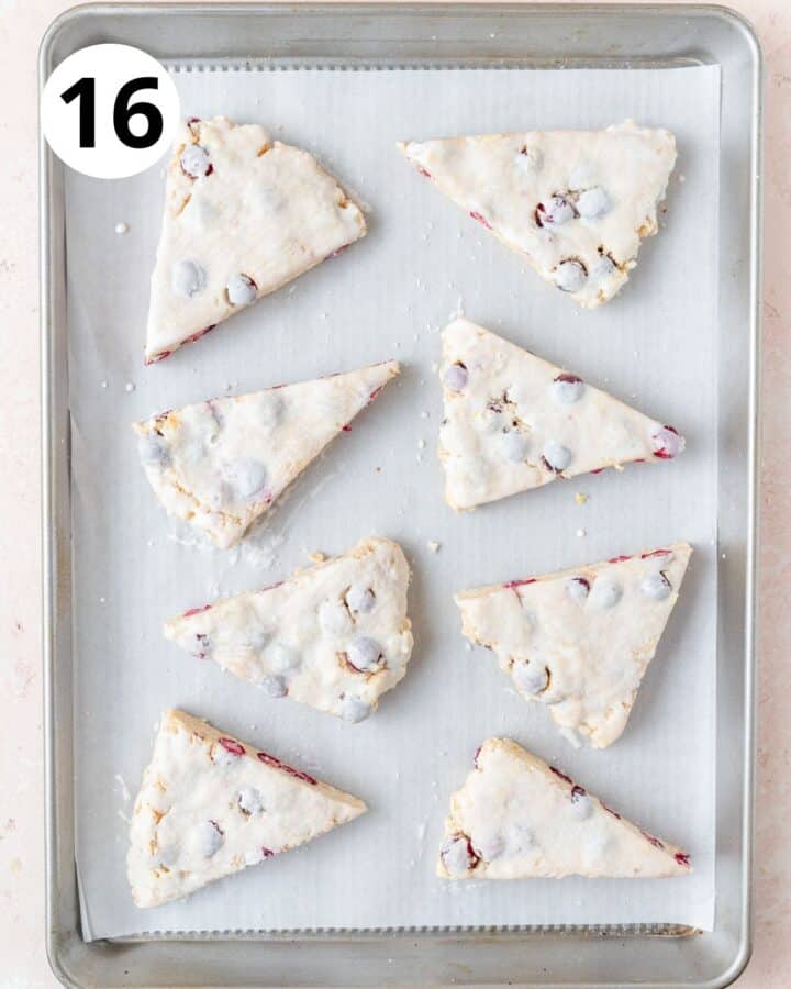 cranberry scones brushed with cream before baking.