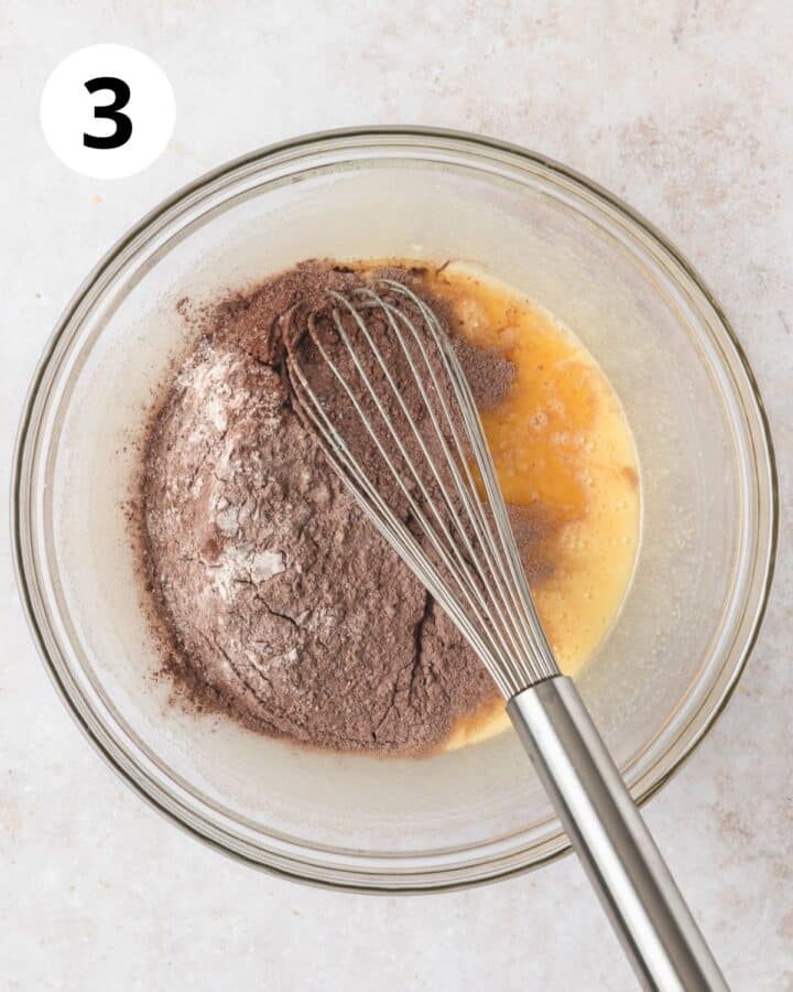 adding dry ingredients to cupcake batter.