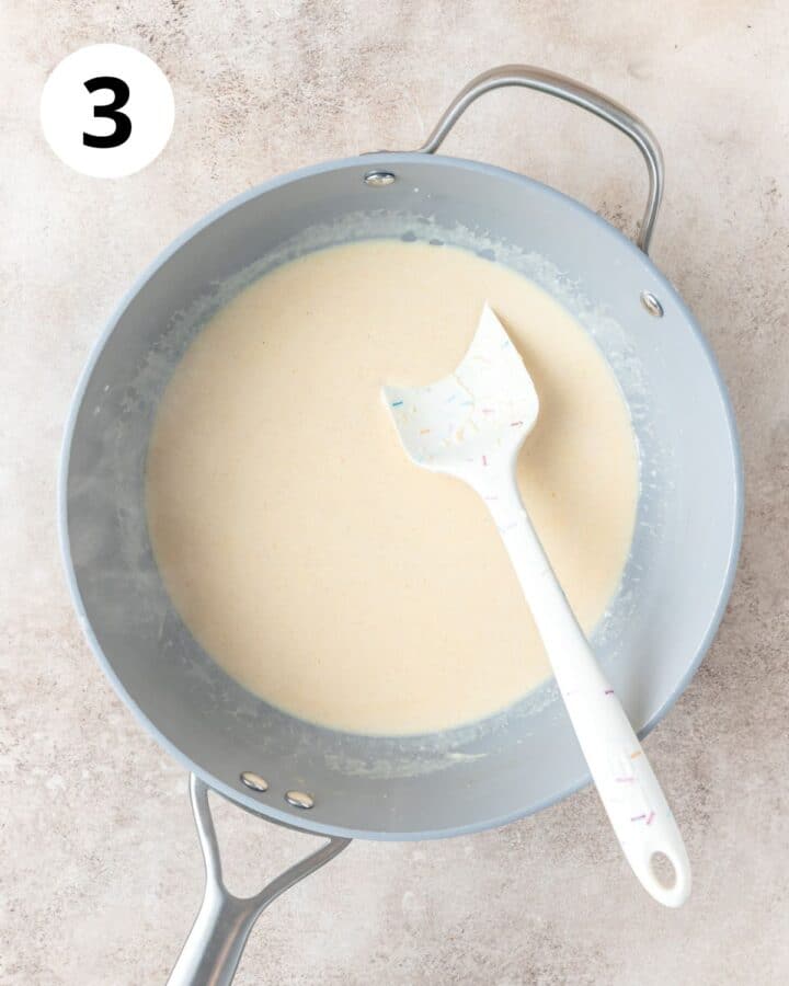 adding milk to make sauce.