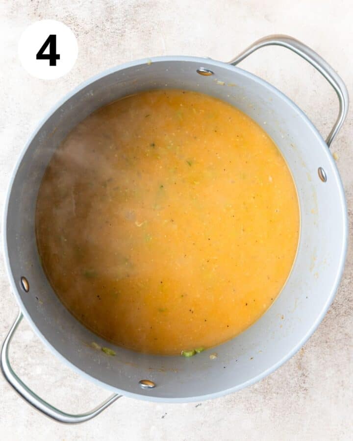 adding vegetable stock to soup.
