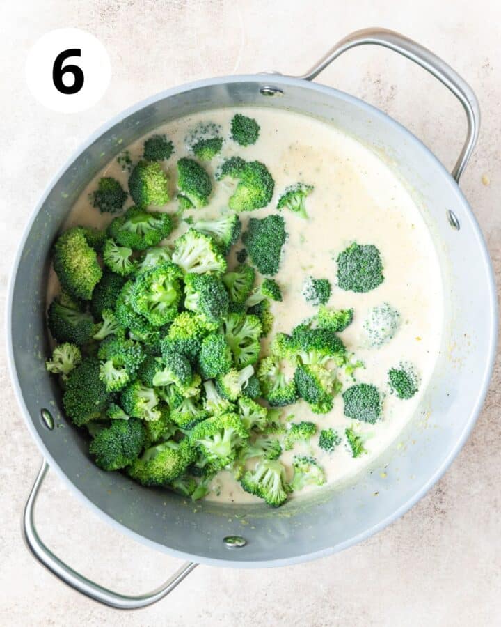 adding broccoli florets to soup.