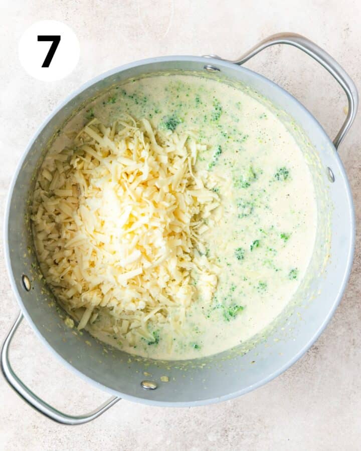 adding white cheddar to soup.