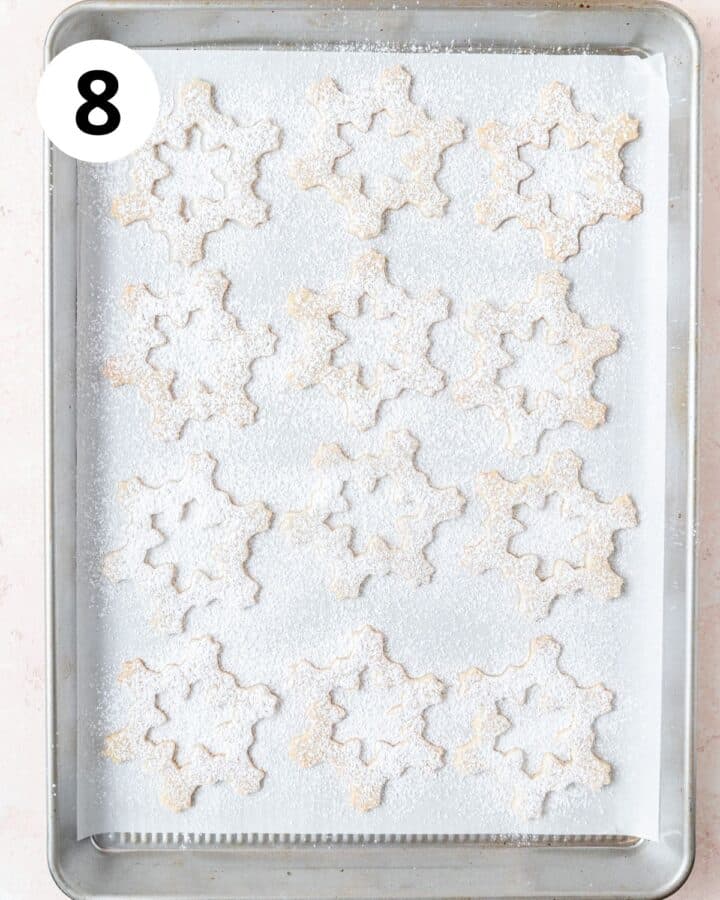 dusting the top halves of the linzer cookies with powdered sugar.