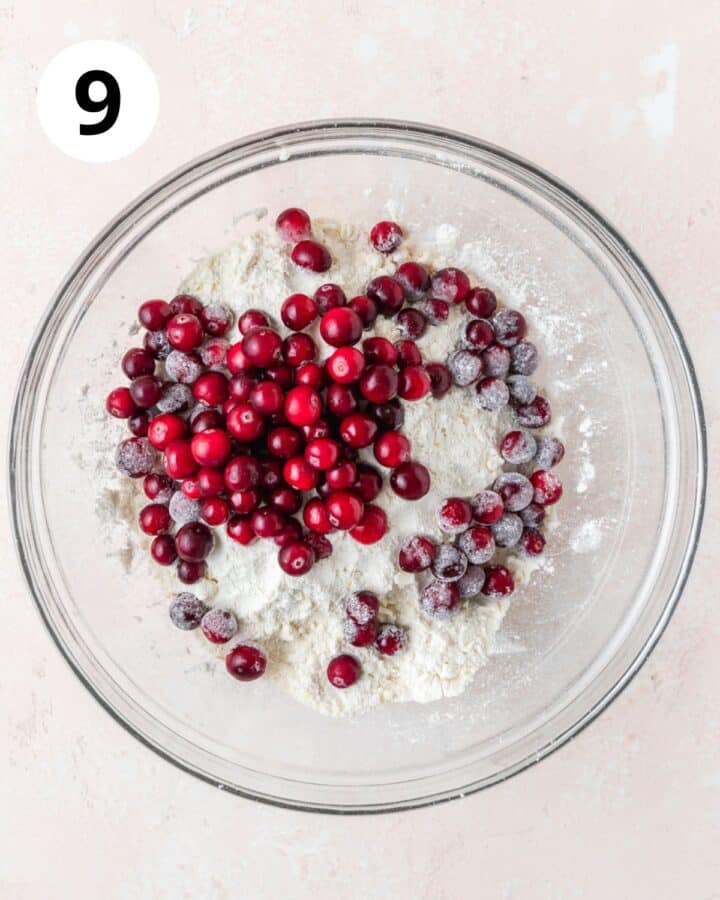 adding frozen cranberries to flour.
