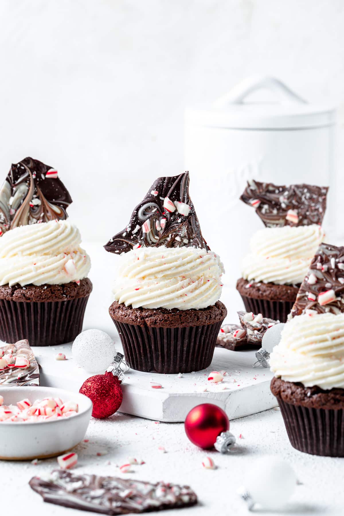 topping chocolate cupcakes with peppermint bark.