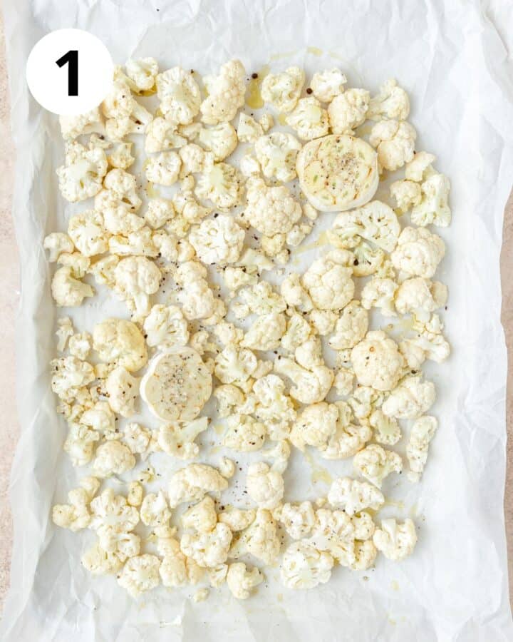 cauliflower and garlic on baking sheet.