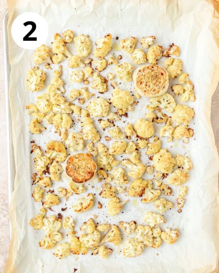 roasted garlic and cauliflower on baking sheet.