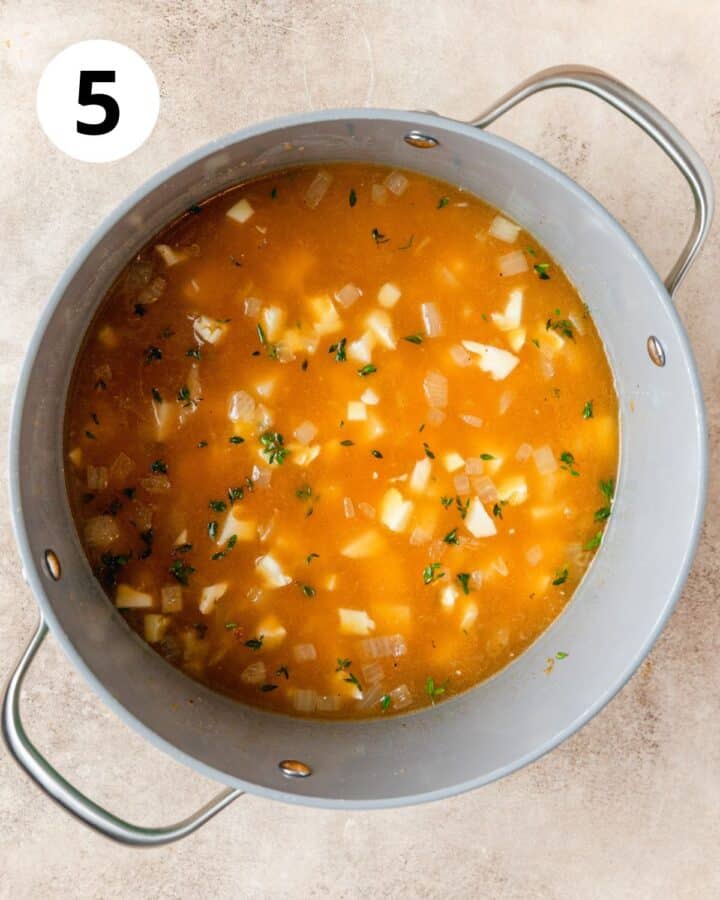 adding broth and potato to soup.