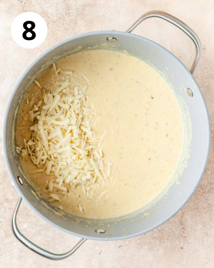 adding shredded gruyere to soup.