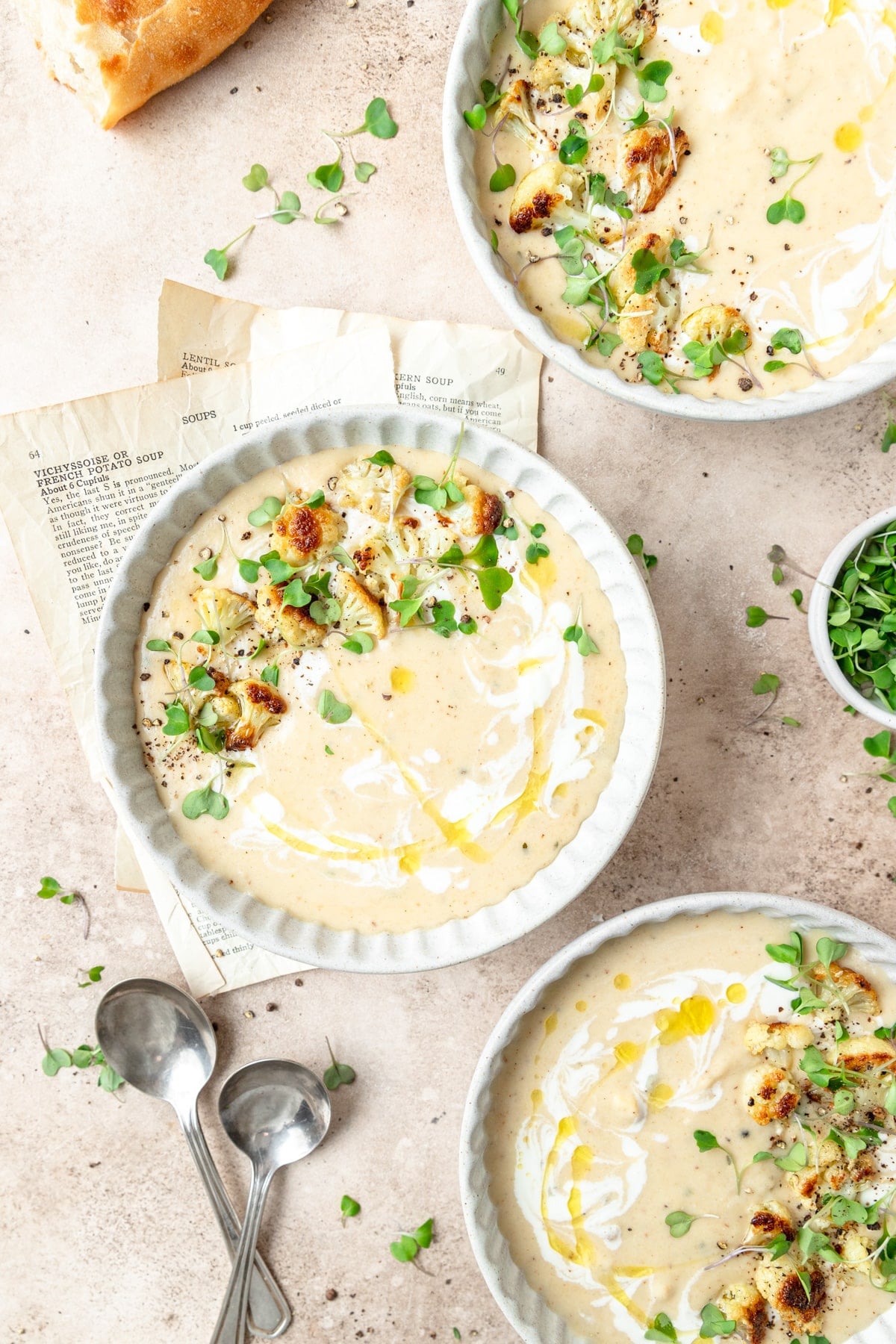 three bowls of roasted garlic cauliflower soup.
