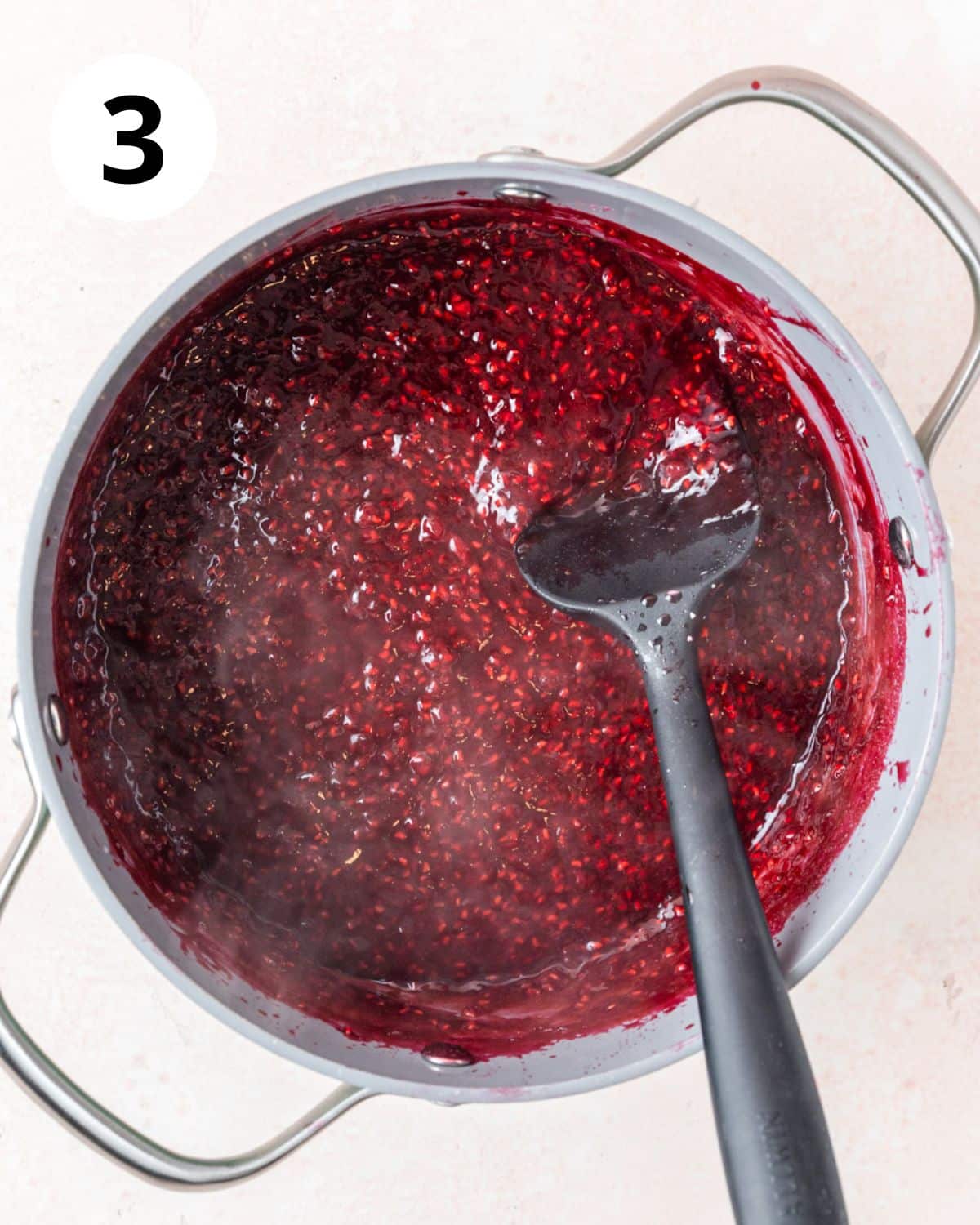 homemade raspberry jam in pot.
