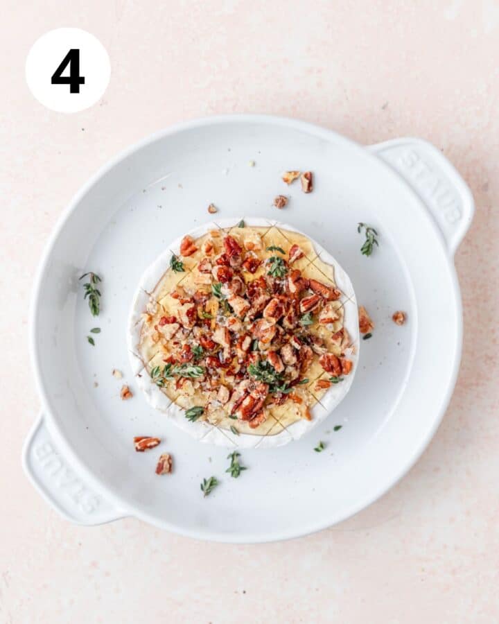 topping brie with pecans and fresh thyme.
