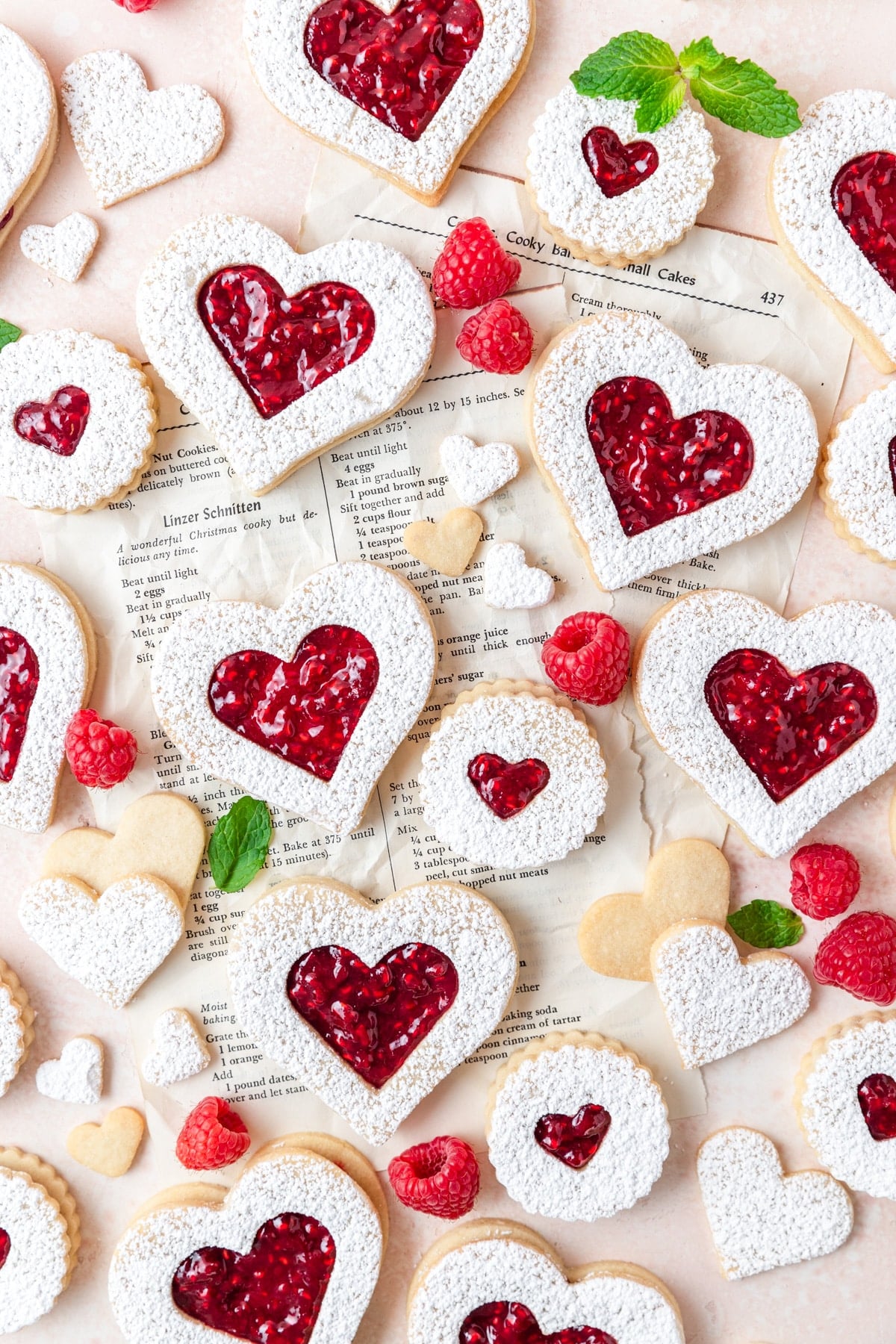 heart shaped linzer cookies after dusting with powdered sugar.