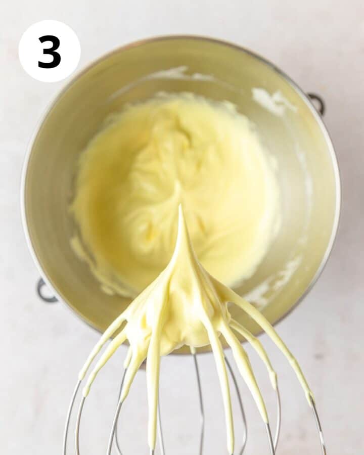 adding yellow food coloring and whipping to stiff peaks.