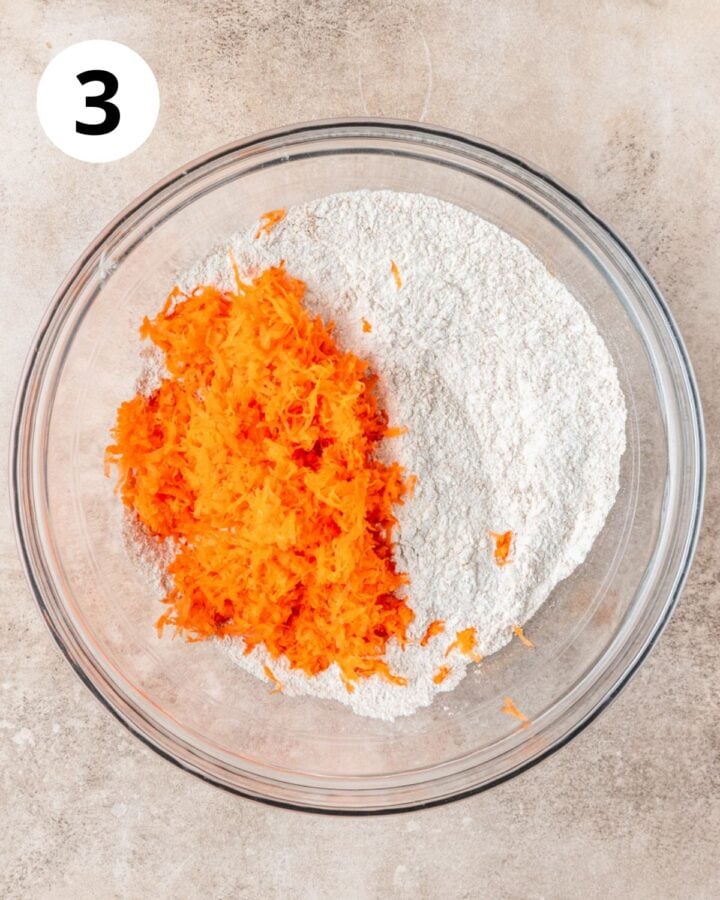 adding shredded carrots to dry ingredients.