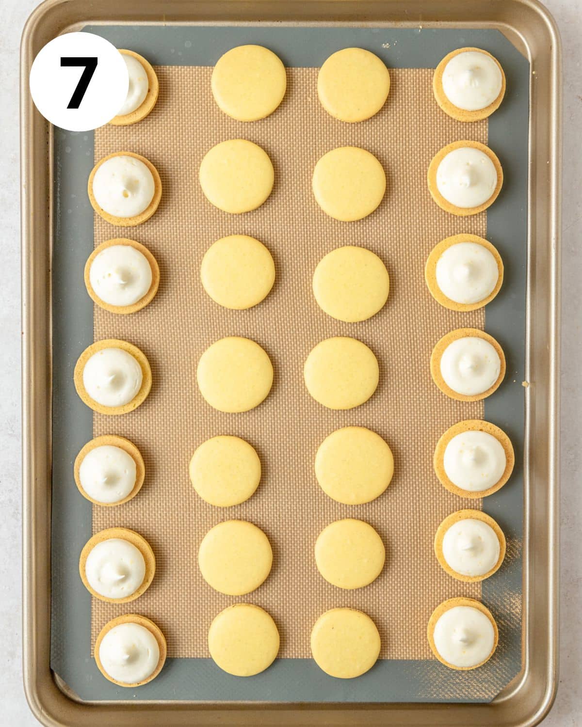 lemon macarons with cream cheese frosting before assembling. 