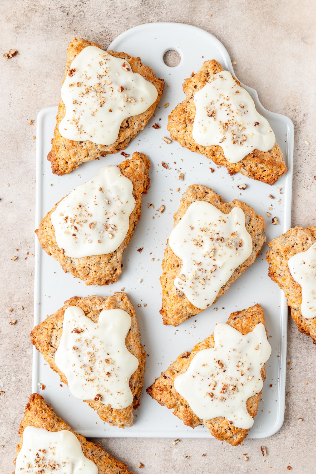 carrot cake scones topped with cream cheese glaze.