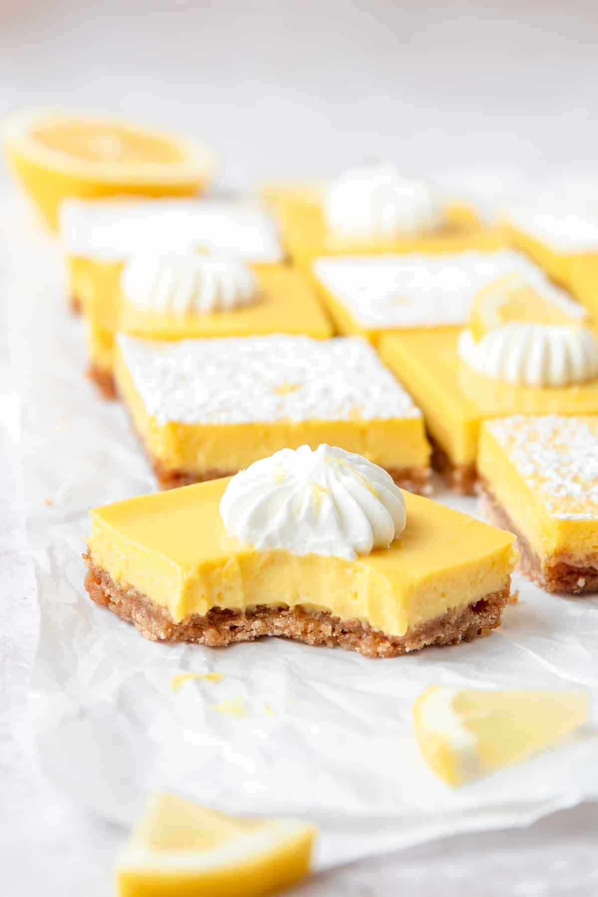 bite taken out of lemon bar with graham cracker crust.