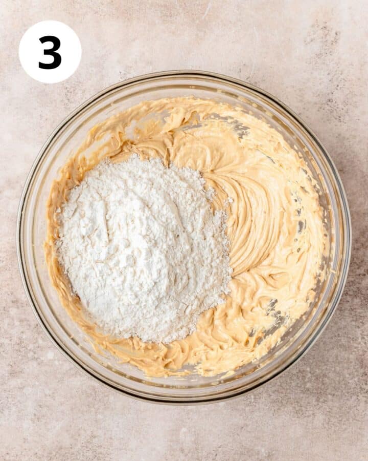 adding dry ingredients to cookie dough.