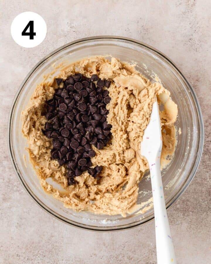 adding chocolate chips to cookie dough.