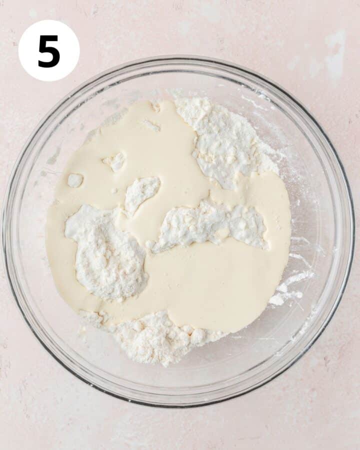 adding wet ingredients to dough.