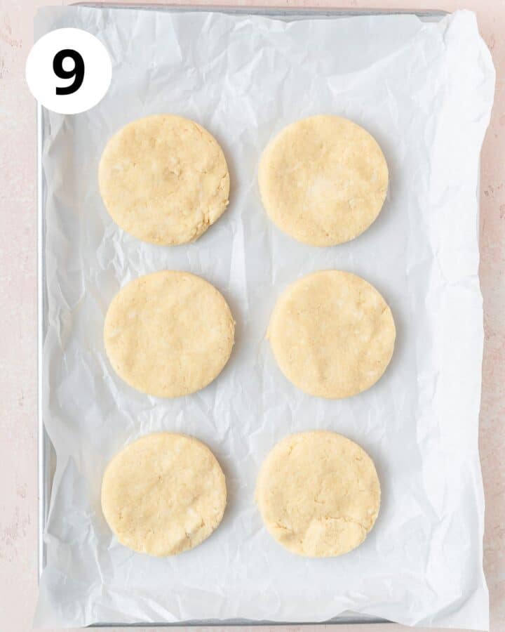 biscuits cut out on baking sheet.