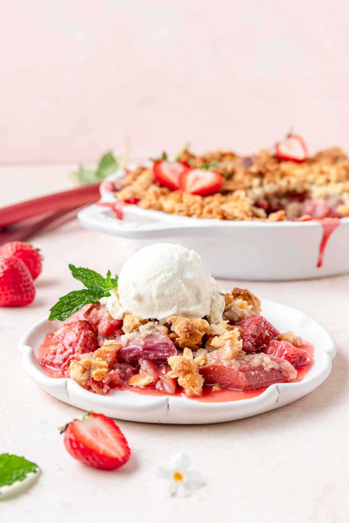 strawberry rhubarb crisp topped with vanilla ice cream.