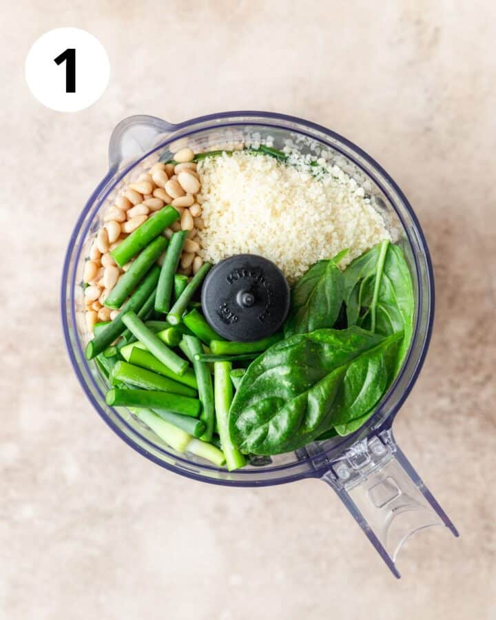 all ingredients for garlic scape pesto in food processor.