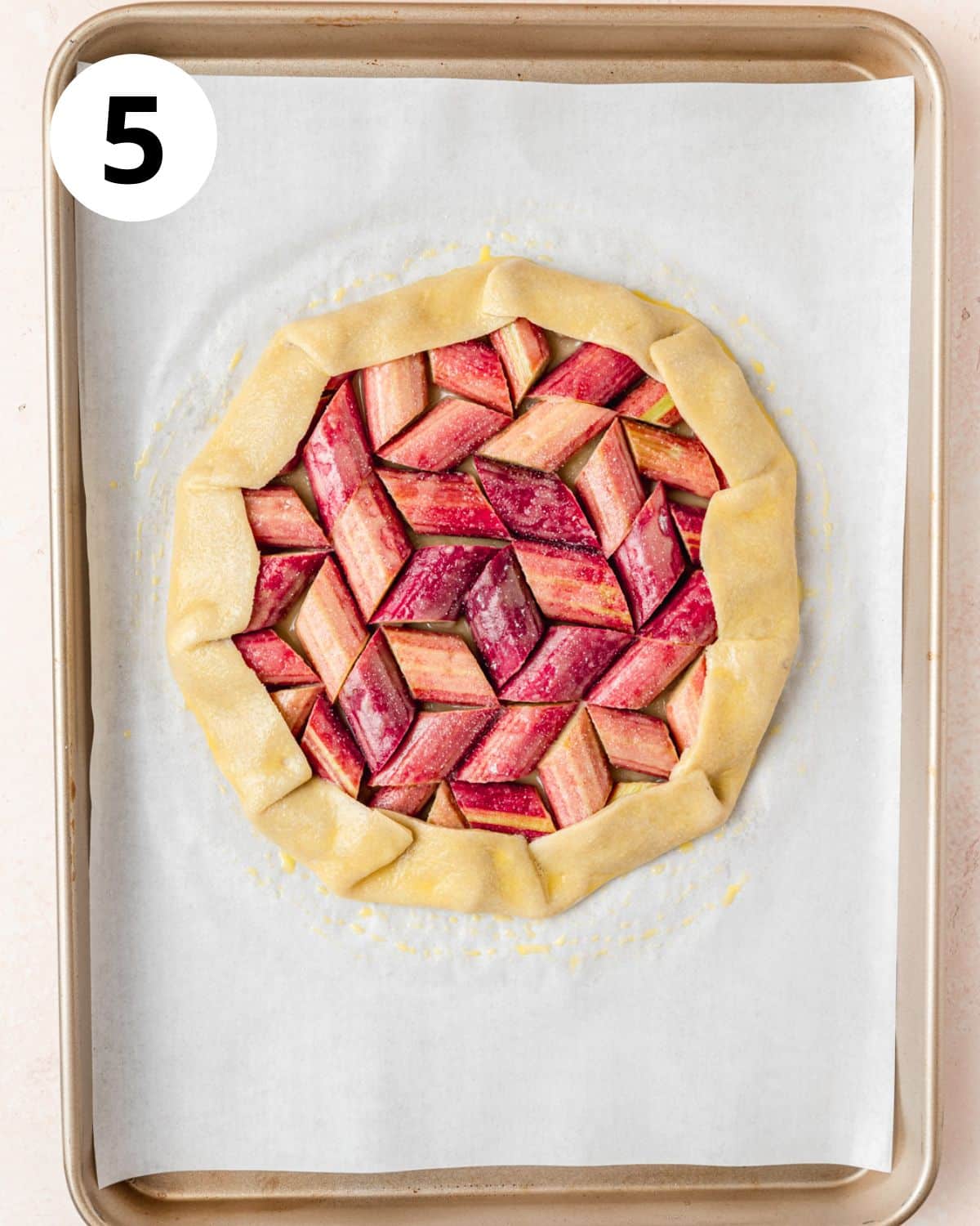 edges of pie crust folded up over rhubarb.