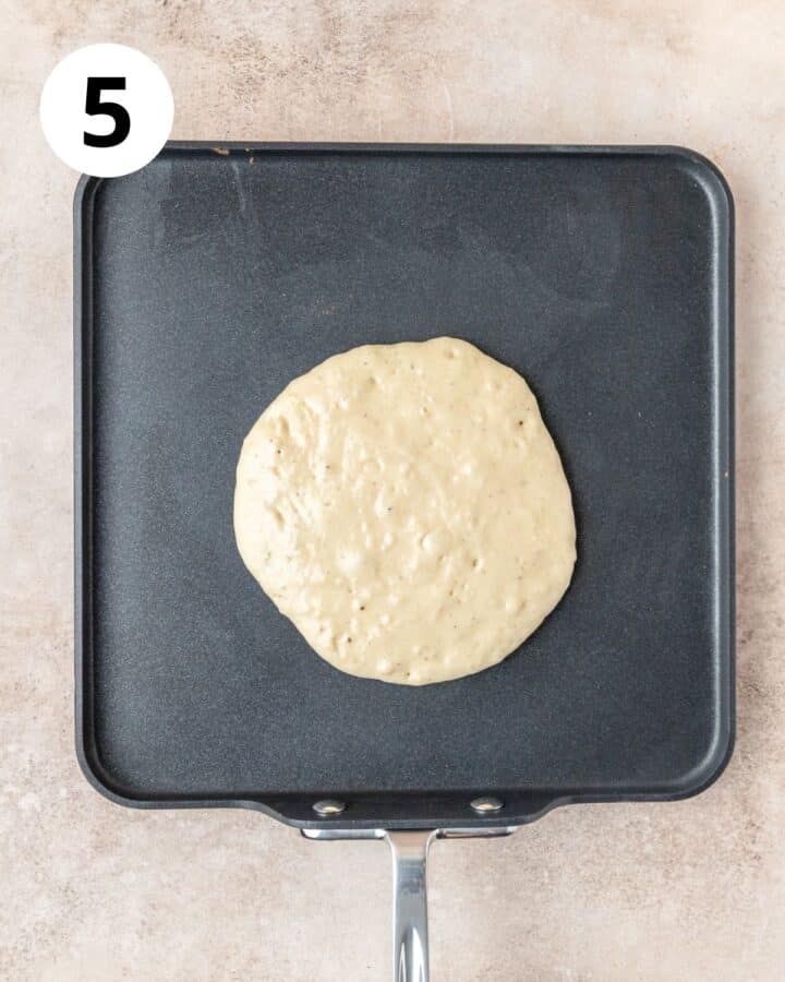 eggnog pancake cooking on griddle.