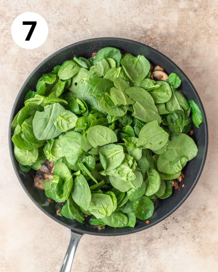 adding fresh spinach to pan.