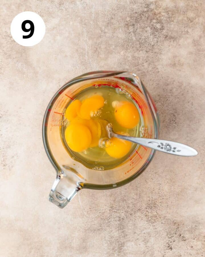 whisking eggs in measuring cup.