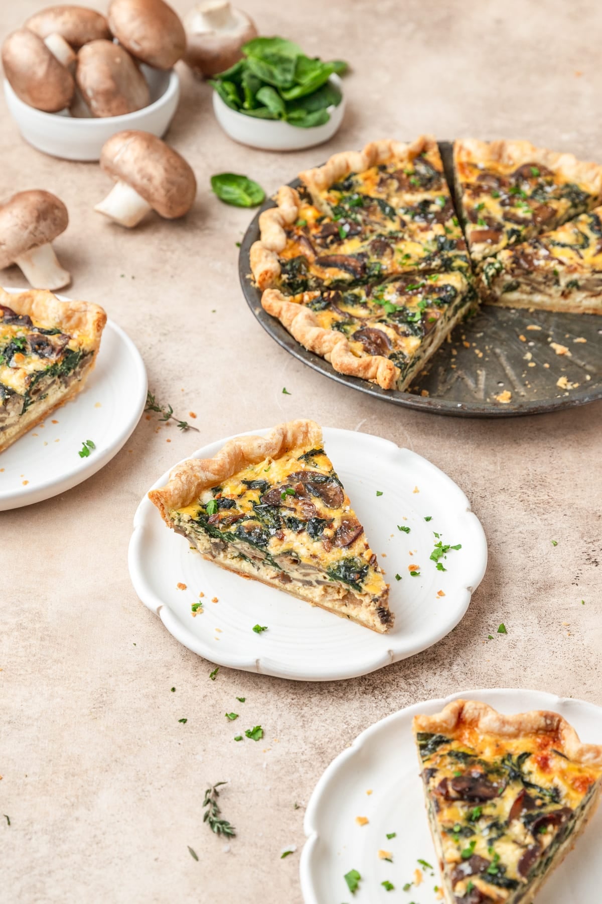 slice of spinach mushroom quiche on plate.