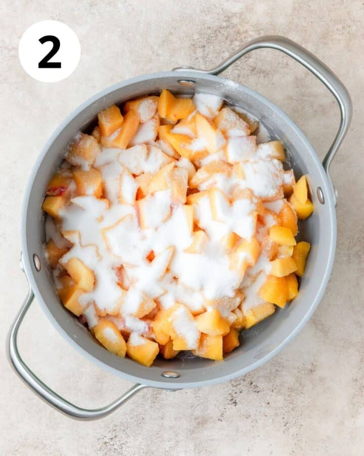 adding sugar to peaches.
