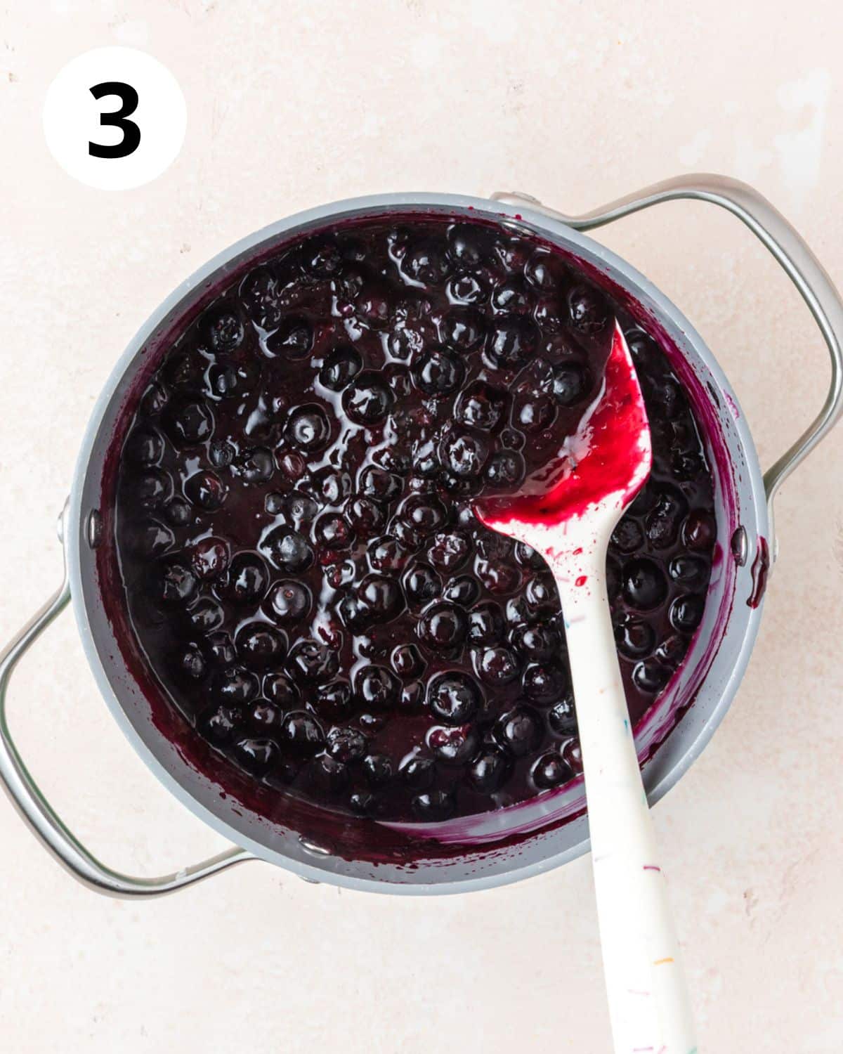 cooked blueberry filling in pot.