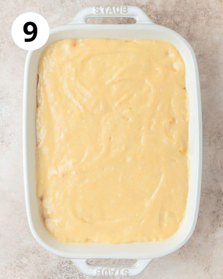 pouring cornbread batter over peaches.