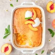 cornbread peach cobbler topped with ice cream.