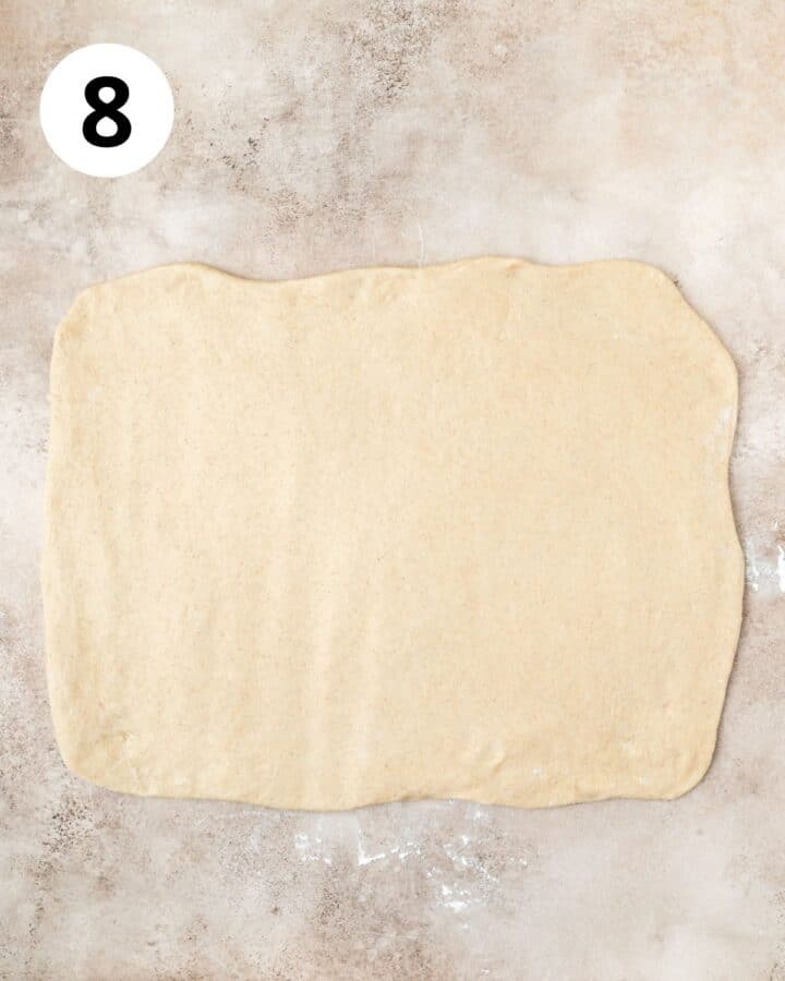 cinnamon roll dough rolled out into large rectangle. 